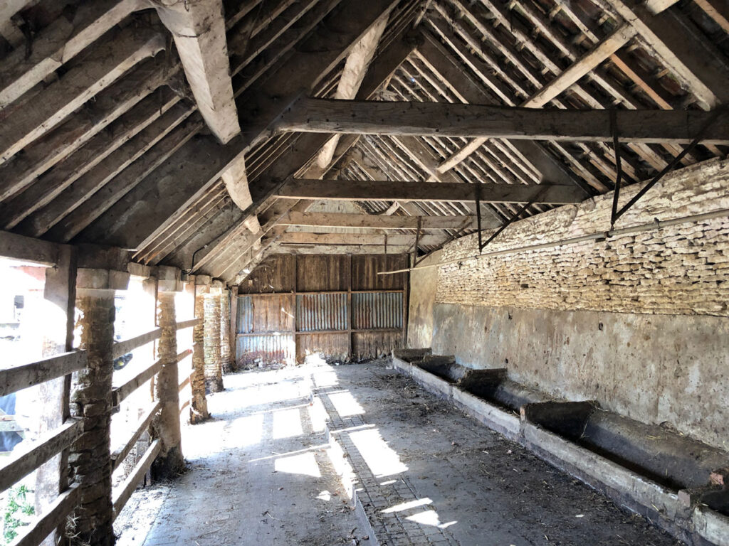 Interior of a barn before work starts at The Farmyard in Grittleton, Wiltshire
